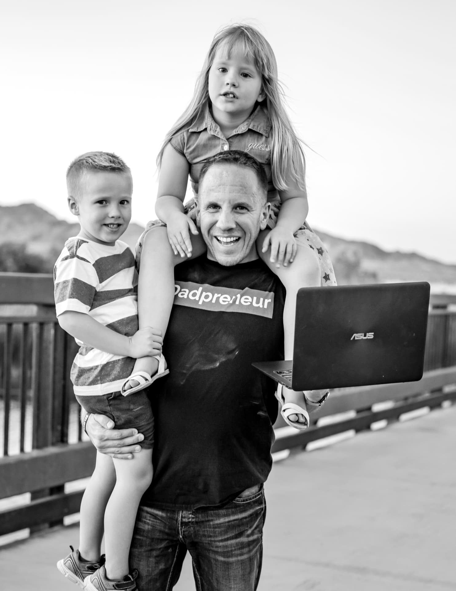 Adam Dukes with his two kids and a laptop